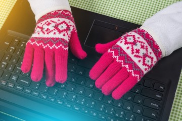 Using laptop in a cold winter, Female with gloves on.
