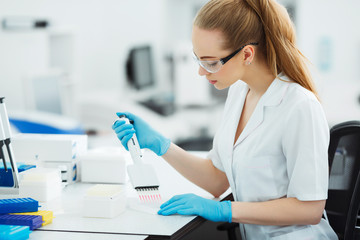 Pipette dropping a sample in a test tube. Laboratory assistant analyzing blood in lab. Aids, hiv test