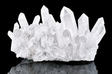 Pure Quartz Crystal cluster isolated on black background. Natural translucent crystal stone surface macro closeup. Macro of beautiful rare mineral stone