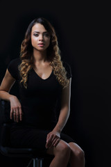 Fototapeta na wymiar young gorgeous caucasian brunette in dress on chair