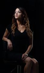 Fototapeta na wymiar Studio shoot of beauty woman posing on the chair