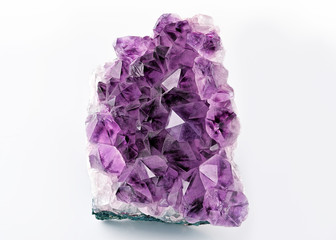 Crystal Stone macro mineral, purple rough amethyst quartz crystals on white background