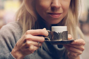 Woman enjoying turkish coffee close up