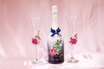 Beautiful decorated wedding glasses with bottle champagne