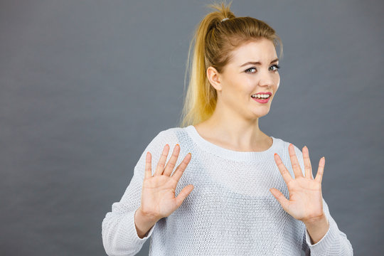 Scared woman gesturing stop gesture with hands