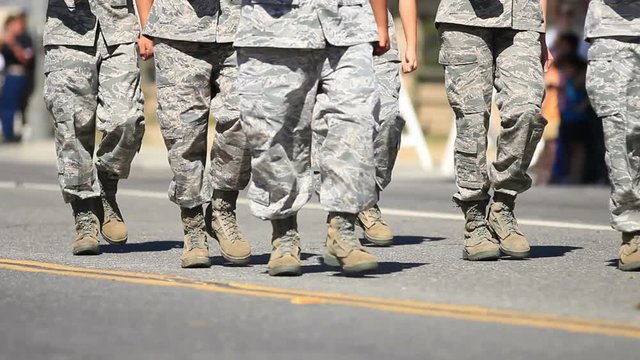 People in camo march down road