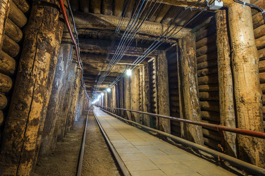 Illuminated underground tunnel in old mine