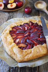 Homemade tart galette with red plums and walnuts
