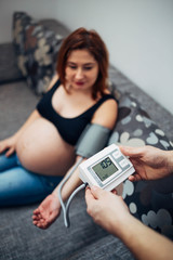 Pregnant woman checking her pulse