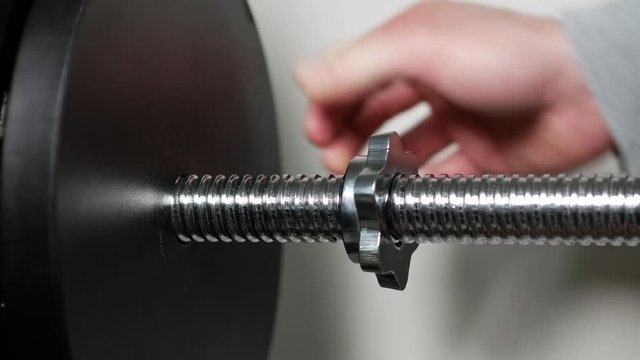 Dumbbell, large nut close-up, screw with large thread