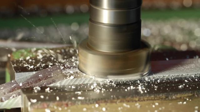 The milling machine mills the duralumin part.