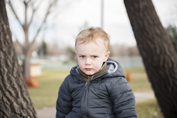 Portrait of a Toddler Boy Outside at a Local Park. Dressed Warmly for Winter.