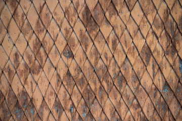 Old weathered wooden wall with ornament painted in brown and blue. Vintage texture Background.