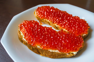Red caviar on bread.