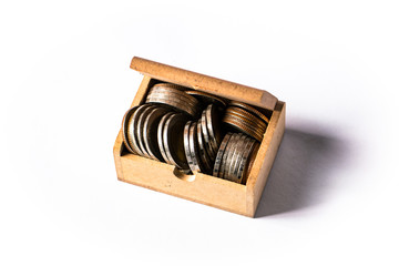 Thai coins in open wooden box isolated on white background.