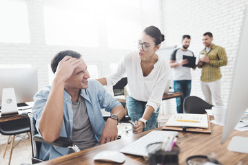 The girl is trying to help a man in a wheelchair, which became ill.