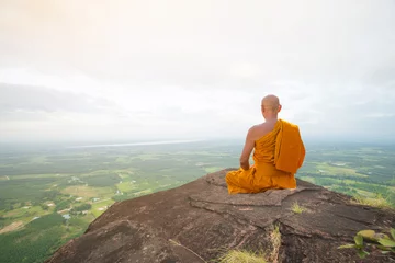 Papier Peint photo Bouddha Buddhist monk in meditation at beautiful nature on high mountain