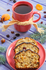 Cup of tea, fresh baked fruitcake for Christmas time and spruce branches