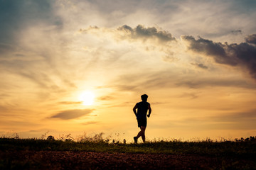 Silhouette man running on sunset