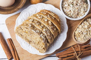 Top view of sliced wholegrain bread on a wooden cutting board.