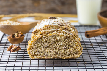 Top view of sliced wholegrain bread on a wooden cutting board.