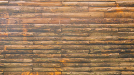 Natural wooden wall on a house, stacked as patern in horizontal, Beuatiful texture, retro style, vintage toned color, use as background.