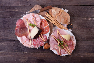 Sliced appetizers for antipasti on rustic table