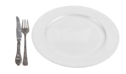 Fork and knife on a empty plate