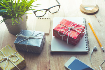 Cute gift box presents on worktable background.For christmas,new year,birthday and happiness concepts