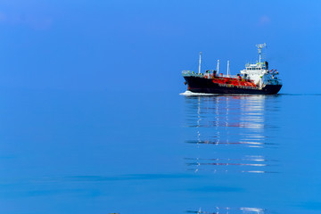 Fototapeta premium minimalist of cargo ship boat on the sea Minimal style with colorful of cloud and sky background