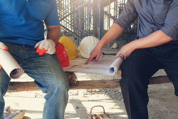 Construction concepts, Engineer and Architect working at Construction Site with blueprint, Vintage Effect