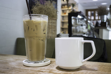 Hot coffee and iced coffee on wooden table