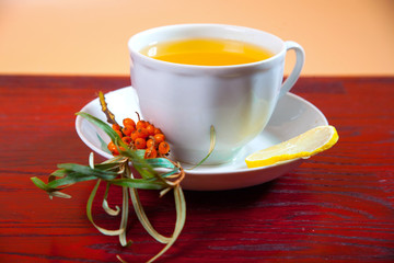 Tea made from sea buckthorn berries healthy for health delicious, saturated with vitamins surrounded by berries and sea buckthorn leaves for family tea drinking and maintaining health in the body