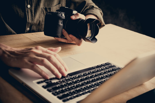 Close up of photographer editing his images on laptop.