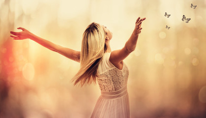 Beautiful woman standing with arms wide open