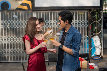 Happy time, elegant woman and young man at the party drinking alcoholat corporate party in restaurant, Age 20-30 years. Party, drinks, holidays and celebration concept.