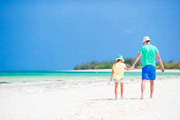 Little girl and dad during tropical beach vacation
