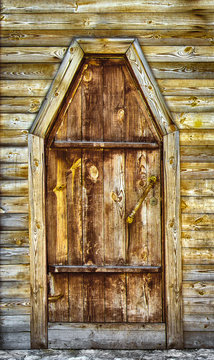 An old wooden door in a wooden building.