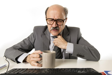 business man 60s working stressed and frustrated at office computer laptop desk looking tired and overwhelmed