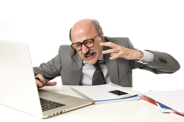 bald business man 60s working stressed and frustrated at office computer laptop desk looking tired