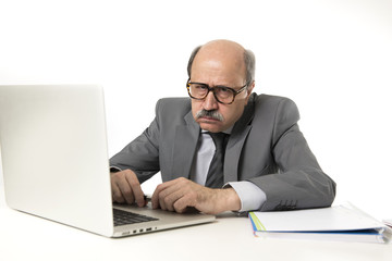 senior mature busy business man with bald head on his 60s working stressed and frustrated at office computer laptop desk looking angry