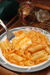 Penne with  sauce on a fork