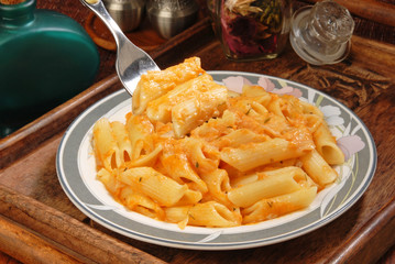 Penne with  sauce on a fork  
