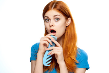 Young woman on white isolated background, hairbrush, hairstyle, haircut