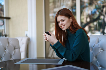 1978425 Beautiful young woman in a cafe on a street in the city