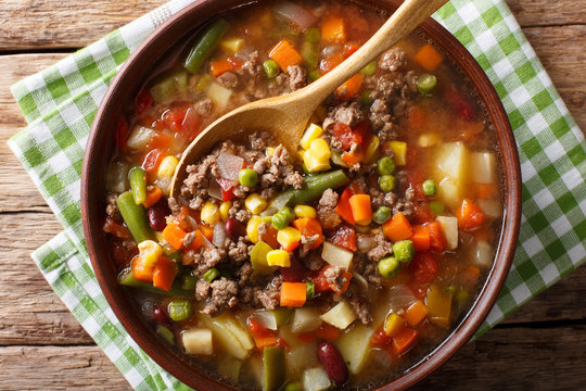 Delicious hamburger soup with ground beef and mix of vegetables close-up. Horizontal top view
