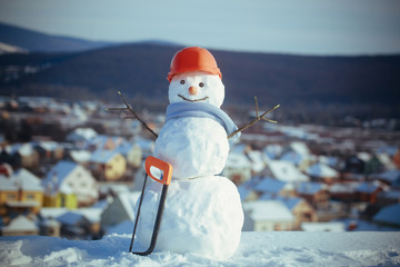Snowman builder in winter in helmet.