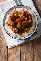 Filipino belly pork hamonado with pineapple and rice close-up. Vertical top view