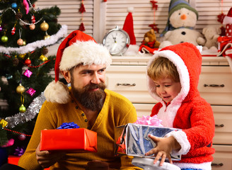 Obraz na płótnie Canvas Christmas happy child and father with present box.
