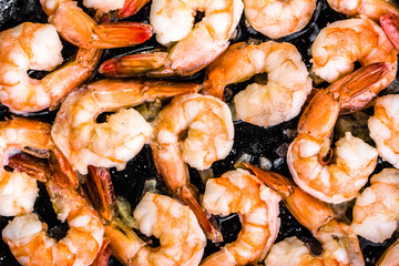 Fried shrimp with garlic on pan, preparing dish with seafood, mediterranean cuisine concept